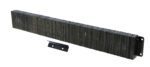 A large stack of industrial metal staples is perfectly aligned like a Vestil Laminated Dock Bumper 12 X 96 X 4.5 In, with one loose staple beside it. The surface has a slightly reflective, metallic sheen.