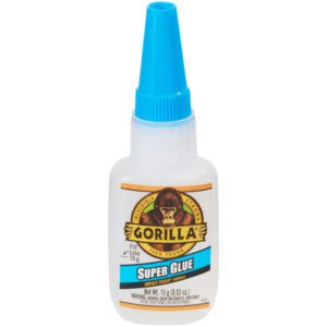 A white bottle of .5 oz. Gorilla® Super Glue with a blue cap and gorilla logo is impact-tough. Sold in a 4/Case set, this essential adhesive keeps you ready for repairs.