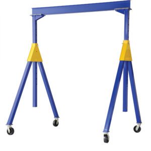The Vestil Knock-Down Adj Steel Gantry 2K 10 X 14 is a blue and yellow portable crane with adjustable height, featuring four caster wheels for easy mobility and a stable structure with a horizontal beam supported by angled legs and triangular braces.