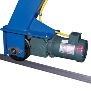 A close-up of a motorized trolley with a blue frame and green motor, reflecting the design of the Vestil Gantry Crane Power Traction 6K to 8K. Mounted on rails, it has yellow cables, indicating power connections for robust traction between 6K and 8K capacity.