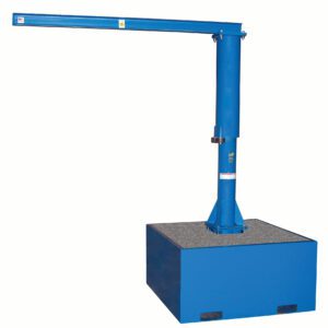 A blue industrial jib crane, known for its long horizontal arm, is stably mounted on the Vestil Additional Steel Base 36 In. Filled W/Concrete, ensuring a robust setup for efficiently lifting and moving heavy loads in industrial settings.