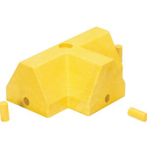 A Vestil Modular Guard Curb - T-Section, featuring a textured yellow angular block with multiple holes and a cutout section, is complemented by two small cylindrical yellow pegs.