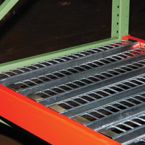 A close-up of metal shelving reveals a sturdy green frame and red support beams, featuring Vestil Open-Area Pallet Rack Decking 38.5 X 120 as the shelf surface, perfect for industrial or warehouse storage.