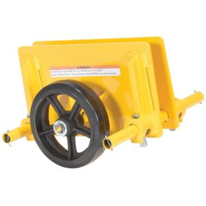 A yellow machinery component similar to the Vestil Adj Panel Dolly 1K Mold On Rubber has a large black wheel, two flat plates, cylindrical extensions on both sides, and a warning label on the rubber surface, indicating its use in industrial or mechanical equipment.