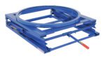 The Vestil Adjustable Pallet Stand W/ Carousel 4K is a blue industrial turntable with a circular platform and rectangular base for rotating heavy objects, featuring a visible side handle with a red grip for seamless manual operation.