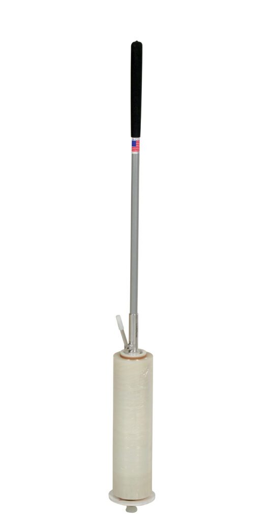 The Vestil Hand Operated Quick Wrapper 60 In has a long metallic handle with a black grip, an American flag detail, and holds a translucent, partially used stretch film roll at the base, making it perfect for wrapping items.