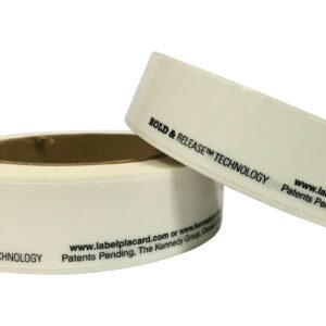 Two white tape rolls with black text HOLD & RELEASE TECHNOLOGY and a website link, stand arranged uniquely. Ideal for use with Vestil Economy Racking Labels 1 In 5 Rolls, this setup ensures seamless organization.