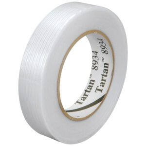 A close-up image features a glossy roll of 1 x 60 yds. Tartan™ Filament Tape 8934, with light reflecting off its smooth texture and the brand name displayed on the inner cardboard ring.