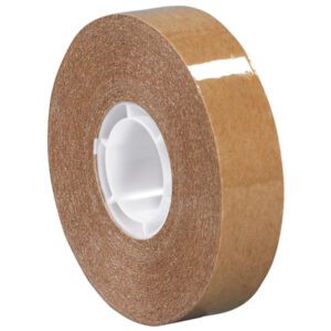 A roll of 1/2 x 18 yds. Tape Logic® Heavy-Duty Adhesive Transfer Tape stands on its edge with a smooth profile and white core, ideal for projects needing the reliable strength offered in every case of 72 rolls.