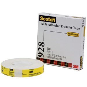 A 3M™ 928 Repositionable Adhesive Transfer Tape roll from the 1/2 x 18 yds. (6 Pack) rests in its package, marked Repositionable. The yellow label signifies it is removable and designed by 3M for versatile adhesive purposes.