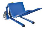 The blue Vestil Tilt Master Ac Power is an industrial lifting machine with a tilting platform and dual forks. It features hydraulic components, rests on a white surface, and is constructed from durable metal with a 4000 lb capacity.