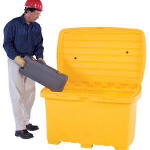 Wearing a red hard hat, blue shirt, beige pants, safety goggles, and gloves, a person places a gray toolbox into an open-lid Vestil Utility Box - Yellow - No Wheels.