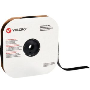 A roll of 1 1/2 x 75 black VELCRO® Brand Tape - Loop - Individual Strips is neatly wound on a white cardboard spool featuring Velcro branding, contact info, and safety notices. A loop extends from the side, highlighting the tapes durability for individual or bulk applications.