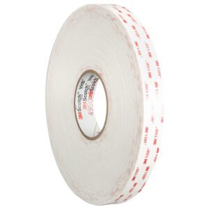 The 1 x 5 yds. White 3M™ 4930 VHB™ Tape (1 Roll/Case) is shown upright with a white backing, distinctive red 3M branding, and a tape core featuring extra red text and logos on a plain white background.