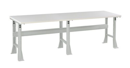 hqhb2alejtud66aa8tkm.jpg A long, rectangular, industrial-style workbench with a smooth, light gray tabletop and sturdy steel legs. The structure includes a horizontal support beam underneath. The design is simple and functional for workshops or labs.