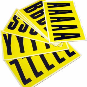 Stacks of yellow sheets show large black letters like A, B, Y, Z, and S neatly arranged on a white surface. These are MH-USA Complete Packs of Self-Adhesive Letters, each measuring H.1.77 in. x W.5.12 in., perfect for creative projects.