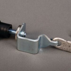 A metal clamp with a black plastic knob from the Justrite Dot Hold Down Replacement Kit rests on a gray surface, accompanied by a separate silver screw.